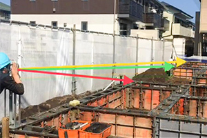 写真：大型物件での通り確認においてメタルフォームN芯上にトランシットを容易に設置できる治具定規、型枠にピンで簡単に固定可能。